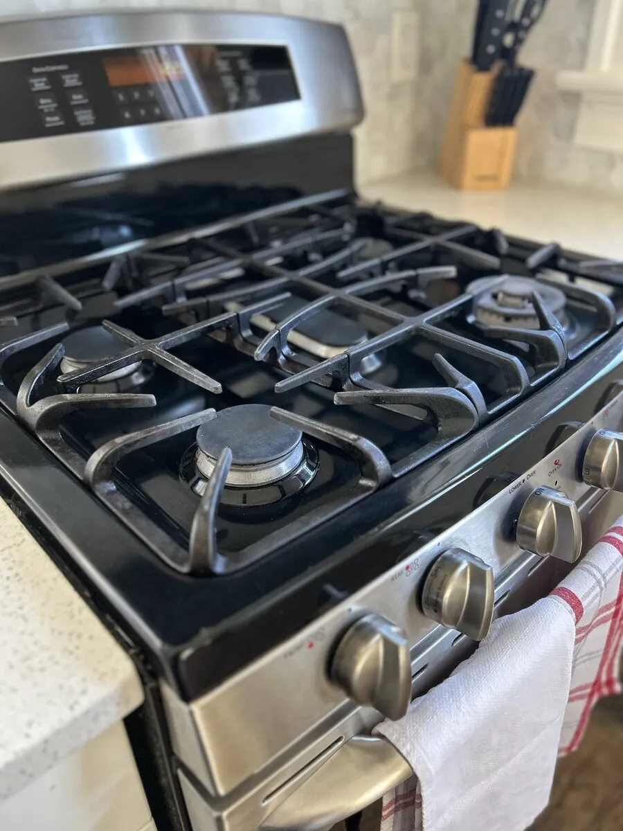 Polished kitchen stovetop and surfaces after house cleaning