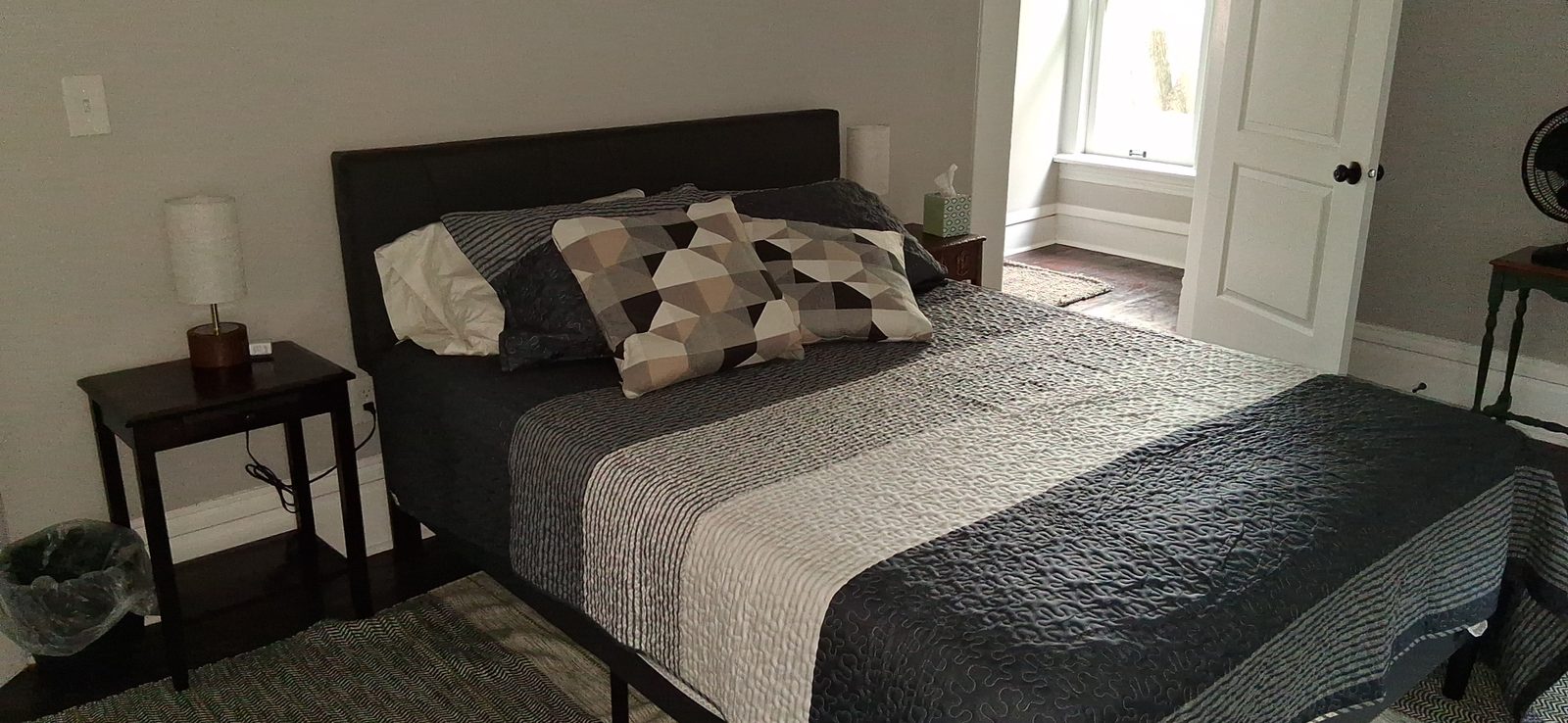 Second bedroom made up between guests Second short-term rental bedroom with a made bed in gray and white linens