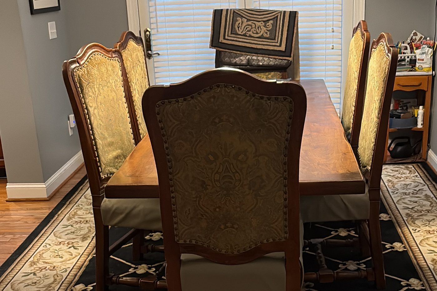 Dining room after a house cleaning visit Dining room with a wood table, upholstered chairs and an area rug over hardwood flooring after cleaning