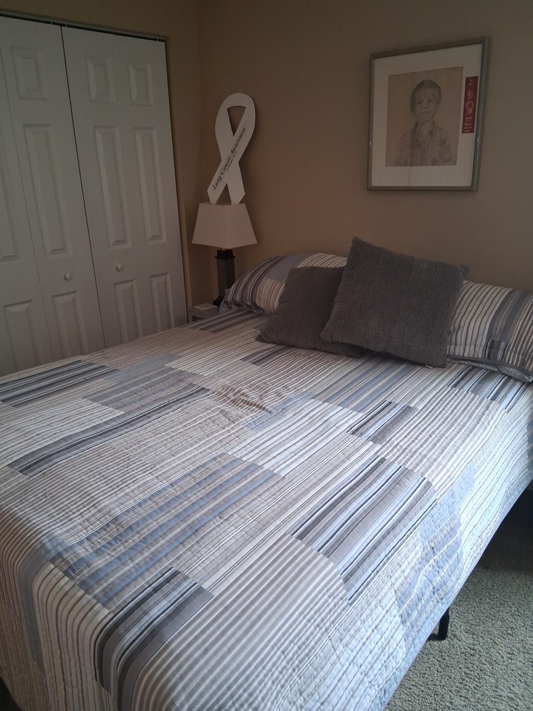 Bedroom after a cleaning visit Guest bedroom with a neatly made bed and pressed quilt after a cleaning visit