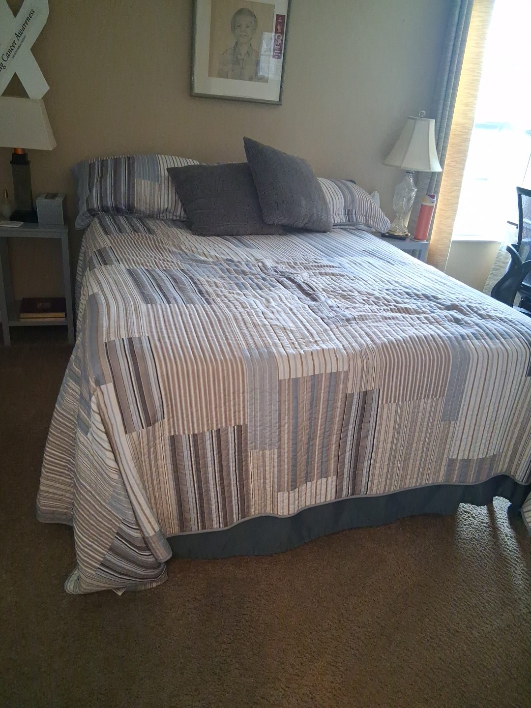 Bedroom on a standard cleaning visit Bedroom with a neatly made quilted bed after a standard cleaning visit