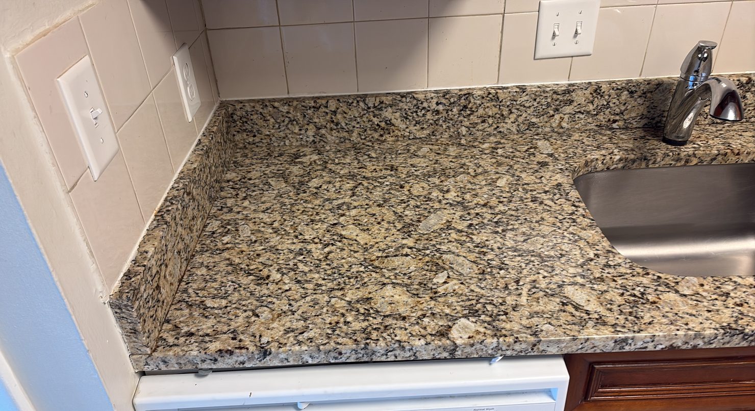 Counters and backsplash on a standard clean Kitchen counter and tiled backsplash cleaned around a stainless sink in a Columbus home
